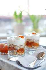 Oats layered with spicy apricot jam. Healthy food concept.