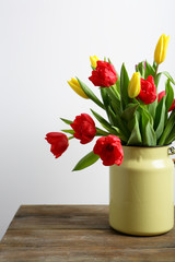 Colorful tulips on a brown table