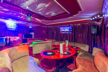 Karaoke room interior with colorful spot lights.