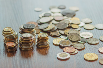 Different gold nad silver collector's coins on the wooden table