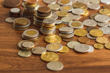 Different gold nad silver collector's coins on the wooden table