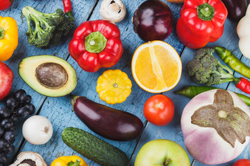 Set of different colorful vegetables and fruits on the wooden background