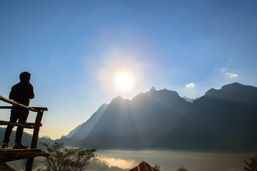Silhouette of person in mountain with sun light. Sport,Success and active life