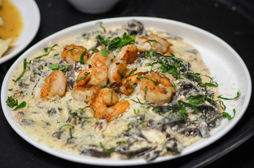 Pasta with shrimp in white sauce.