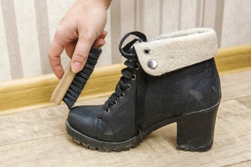 Cleaning shoes with brush