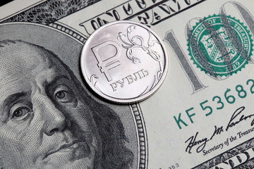 Dollar bill and russian ruble coin