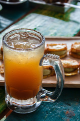 Natural Michelada with lemon and beer in a frozen glass jar. - 138496438
