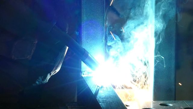Welder at work in metal industry, slow motion