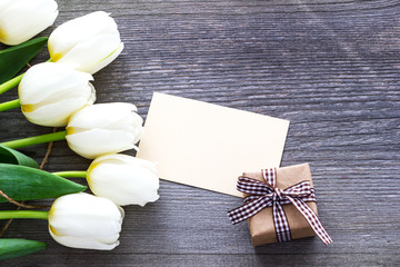 Bouquet white  tulip flowers on old wooden table. Easter.Mothers day.Womans day.Gretting card.
