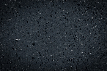 Water drops on dark stone