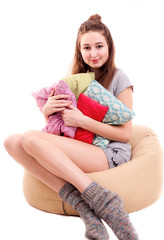 Fototapeta premium Attractive girl play pillow fight isolated