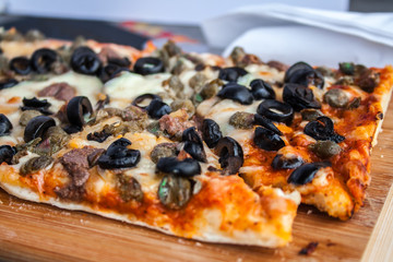 Homemade baked pizza with mushrooms and spices, cheese and tomato.