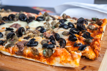 Homemade baked pizza with mushrooms and spices, cheese and tomato.