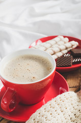 Cappuccino and Chocolate on a Bed with Plaid.