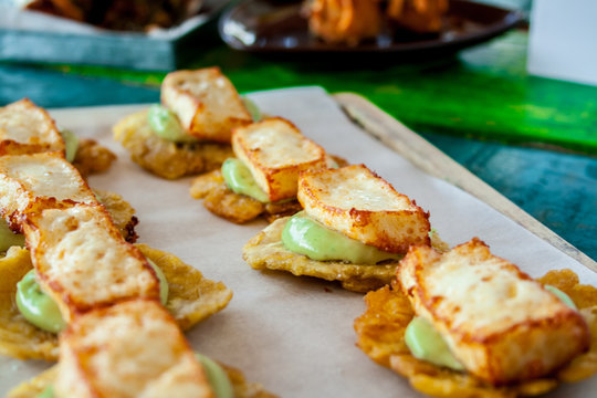 Tostones with abocado and fried cheese