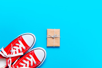 big red gumshoes and beautiful gift on the wonderful blue background
