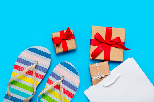 colorful sandals, shopping bag and beautiful gifts on the wonderful blue background