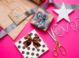 Fototapeta na wymiar cute gifts, star shaped toy and things for wrapping on the wonderful pink background