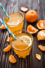 Freshly squeezed tangerine juice on a wooden background