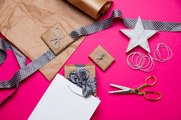 cute gifts, star shaped toy, shopping bag and things for wrapping on the wonderful pink background