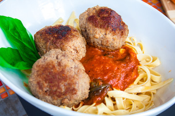 Pasta with meatballs and tomato sauce.