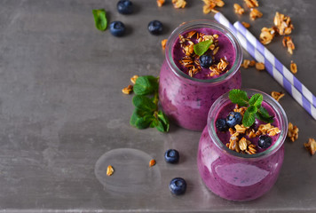 Obraz na płótnie Canvas Berry yogurt with bran and oatmeal on a metal background