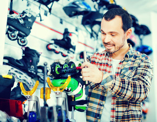 Male repairer fixing roller-skates in sports store