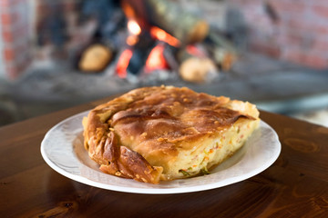 Piece of Traditional Pie by a Fireplace