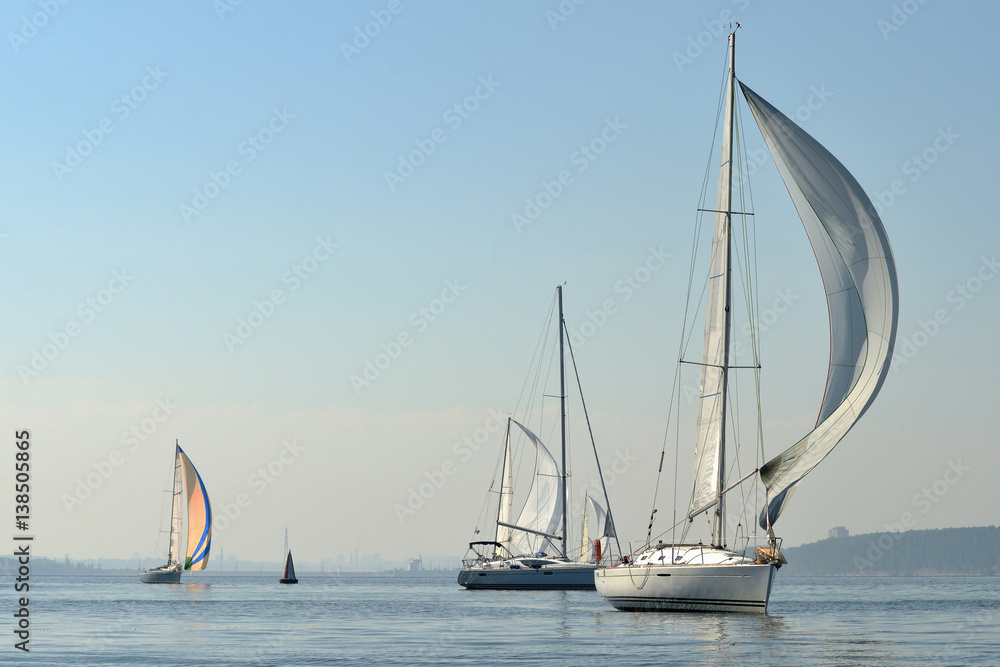 Wall mural sailing boats on the river, the reflection on water in the distance shore.