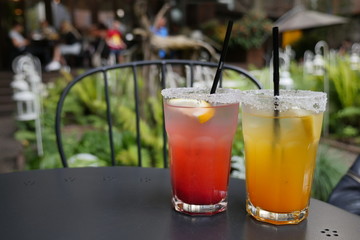 Pitcher of cool lemonade with glass on table. Organic Sweet Blueberry and Orange Lemonade. Refreshing summer drinks. 