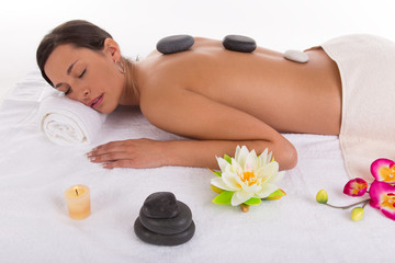 Fototapeta na wymiar Young woman receiving hot stone massage
