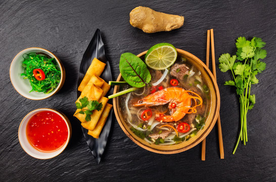 Asian soup pho bo with spring rolls