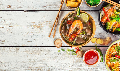 Asian food served on wooden table, top view, space for text