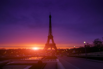 Awesome incredible pink-orange-lilac sunrise. View of the Eiffel Tower from the Trocadero. Beautiful cityscape in backlit morning sunbeam. Paris. France.