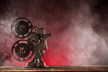 Old style movie projector with smoke on background, close-up.