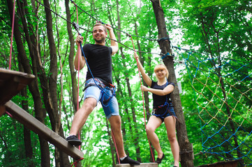 Fototapeta premium Hiking in the rope park two young people