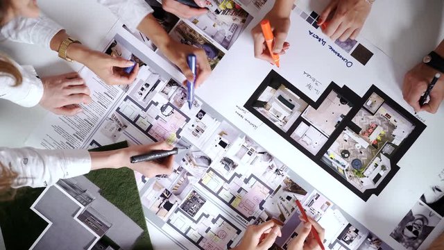 business, people, technology and team work concept - close up of architects with blueprint, smartphones and tablet pc computers sitting at table in office 4k