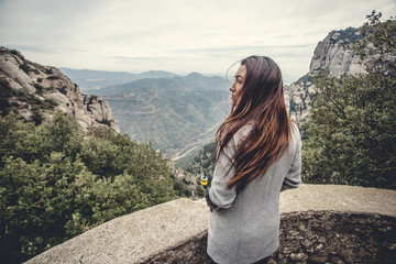 Naklejka premium Young girl in the mountains, walk on the wild