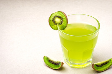 beautiful cocktail with a kiwi/juice and segments of kiwi on a white background