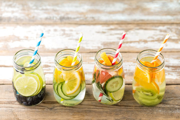Variety of fruit infused detox water in jars for a healthy diet eating