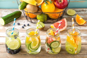Variety of fruit infused detox water in glass jars for a healthy diet eating