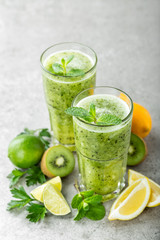 fat burning green fruit cocktail with kiwi, lemon, mint and parsley for slimming and healthy diet