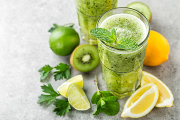 fat burning green fruit cocktail with kiwi, lemon, mint and parsley for slimming and healthy diet