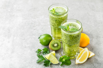fat burning green fruit cocktail with kiwi, lemon, mint and parsley for slimming and healthy diet...