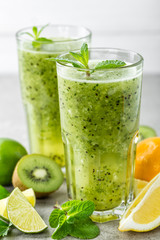 fat burning green fruit cocktail with kiwi, lemon, mint and parsley for slimming and healthy diet