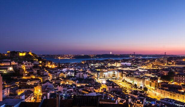 Aerial evening Panorama of Lisbon - illuminated Avenues and river in the background