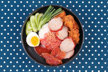 Jasmine rice with meat and boiled egg topped red sweet sauce .