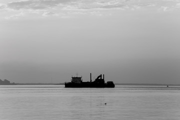 Cargo ship in the sea at dawn