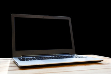 Fototapeta premium Computer on a desk on a black background.
