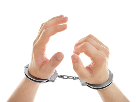 Man hands in handcuffs, isolated on white